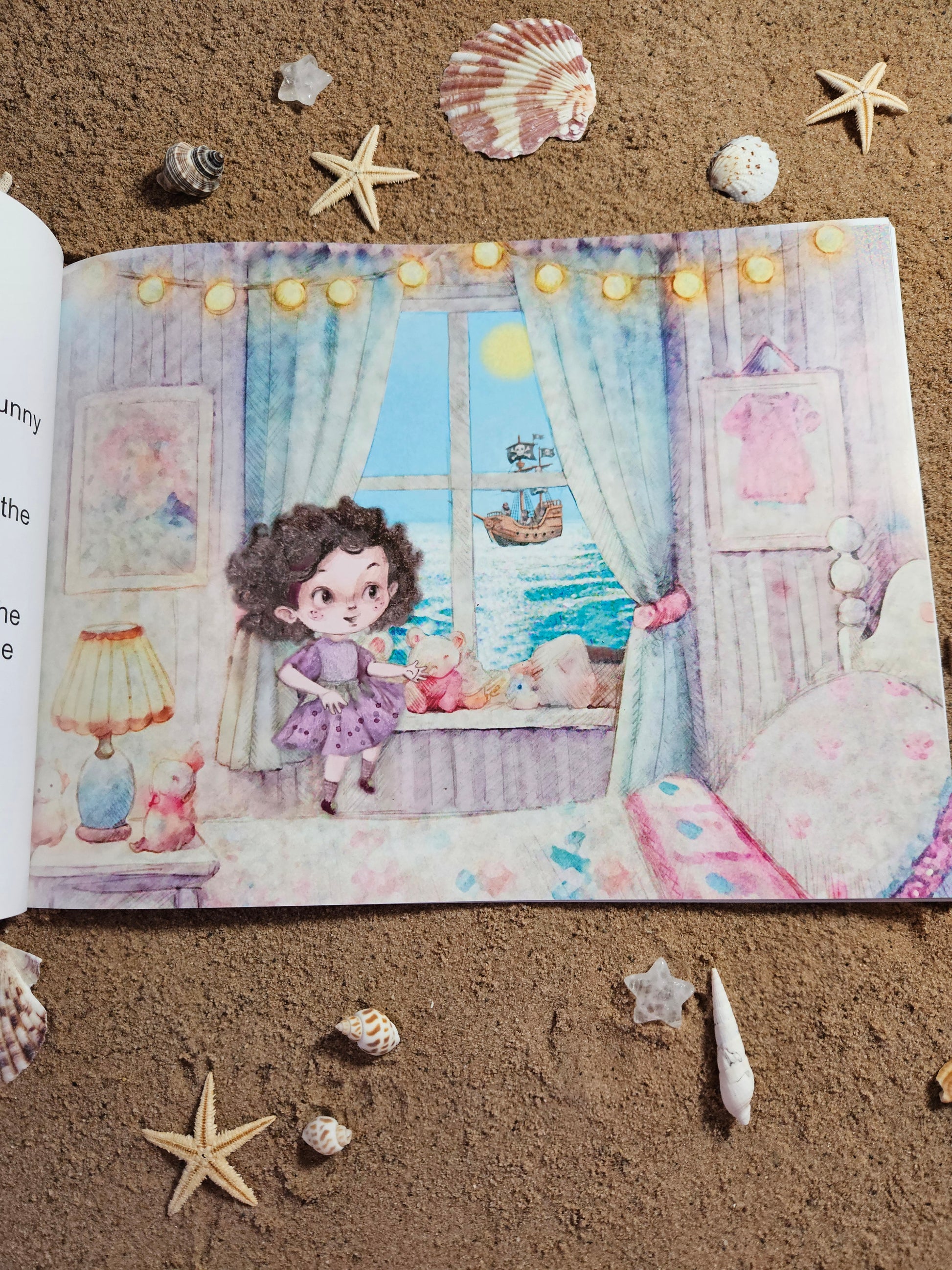 Picture of the book on the page where Dora Mary the Mousehole Fairy is looking out to sea through her bedroom window