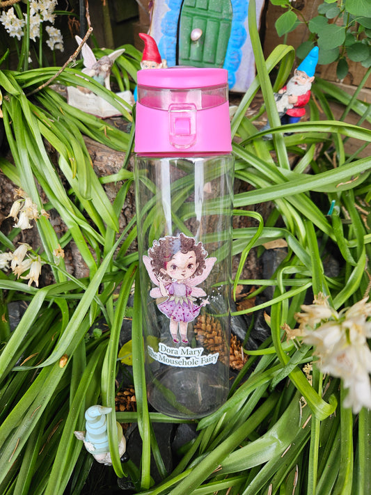 Clear water bottle with a pink lid and Dora Mary the Mousehole Fairy on. Picture background is a fairy garden.
