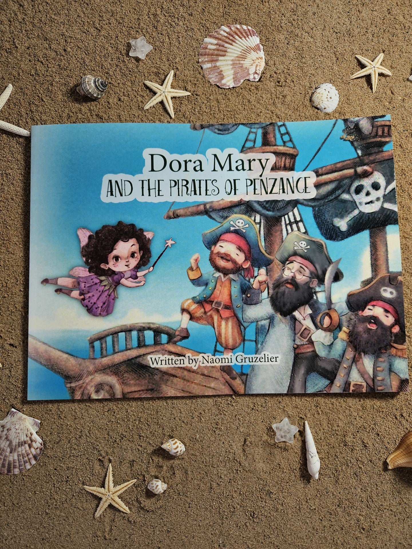 Front cover of a childrens books with the pirates of penzance, and Dora Mary the Mousehole fairy. Captain Joe wears glasses.